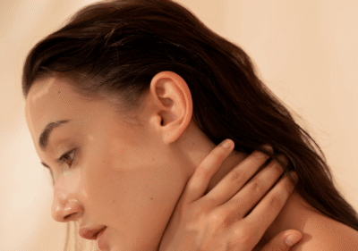 Жена с мазна кожа нанася лек хидратиращ гел върху лицето