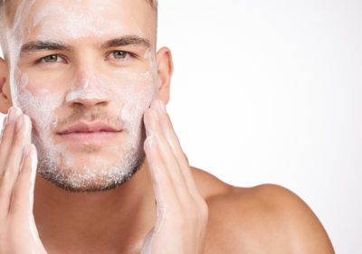 Мъж с чиста, хидратирана кожа и минималистична рутина от три продукта козметика за мъже на рафта